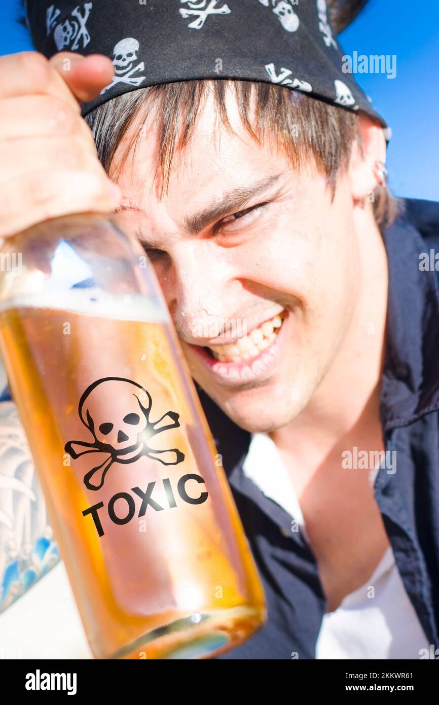 Alcohol Abuse Concept Sees A Drunk Seaman, Sailor Or Pirate Enjoying A Toxic Chemical Beverage Of Spirits Outdoors In The Sun Stock Photo