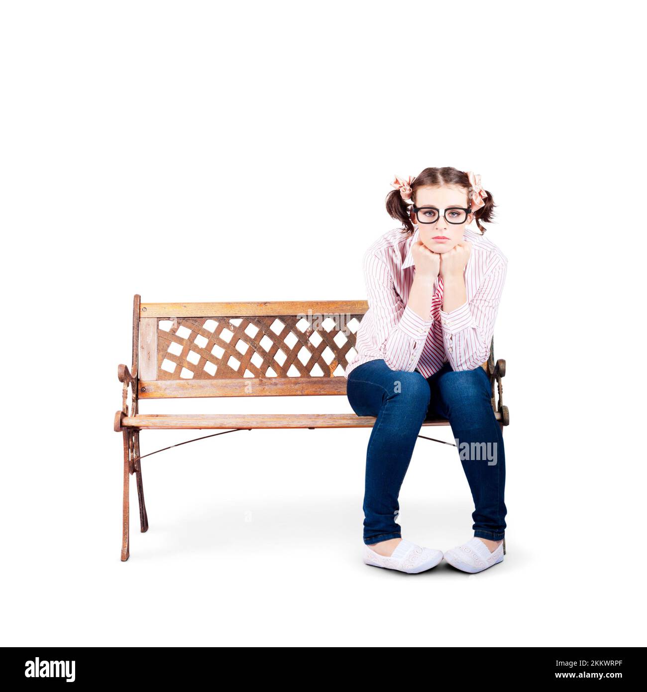 Isolated Photograph Of A Sad Lonely Nerdy Woman Sitting On A Park Bench All Alone On White Background Stock Photo