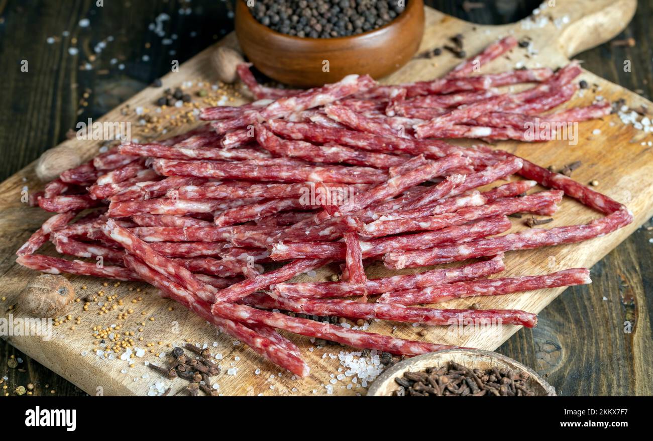 thin dried meat sausages with spices , dried pork meat food while