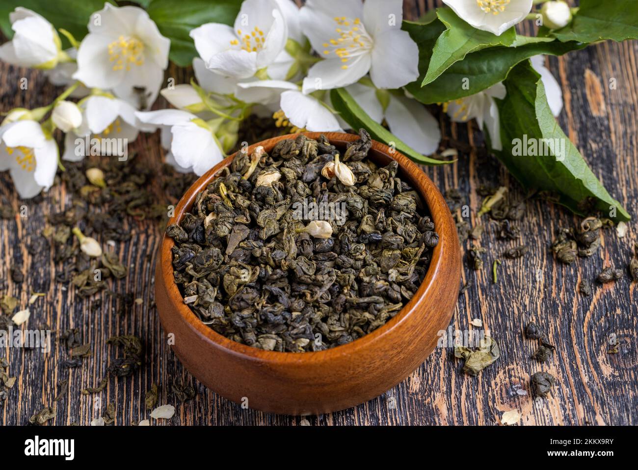 A real green hour with jasmine on the table, dried tea leaf for brewing