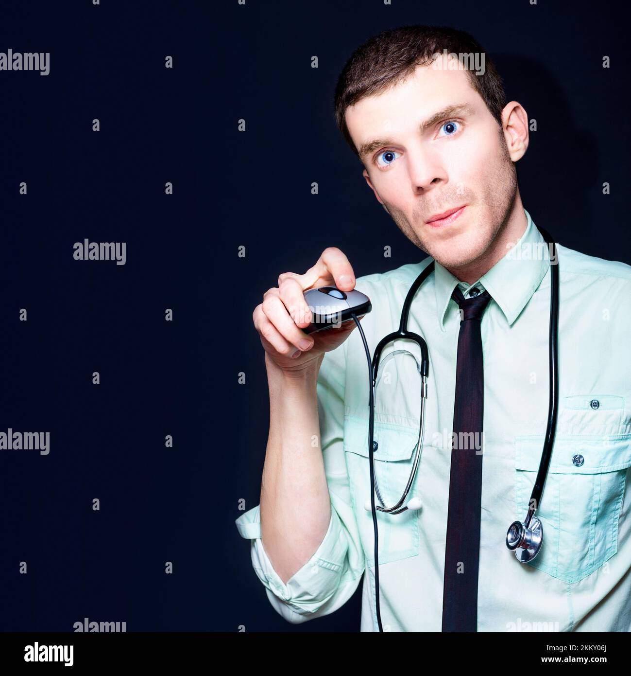Young Modern Professional Doctor Holding Computer Mouse While Searching The Internet For New Age Health Care Stock Photo