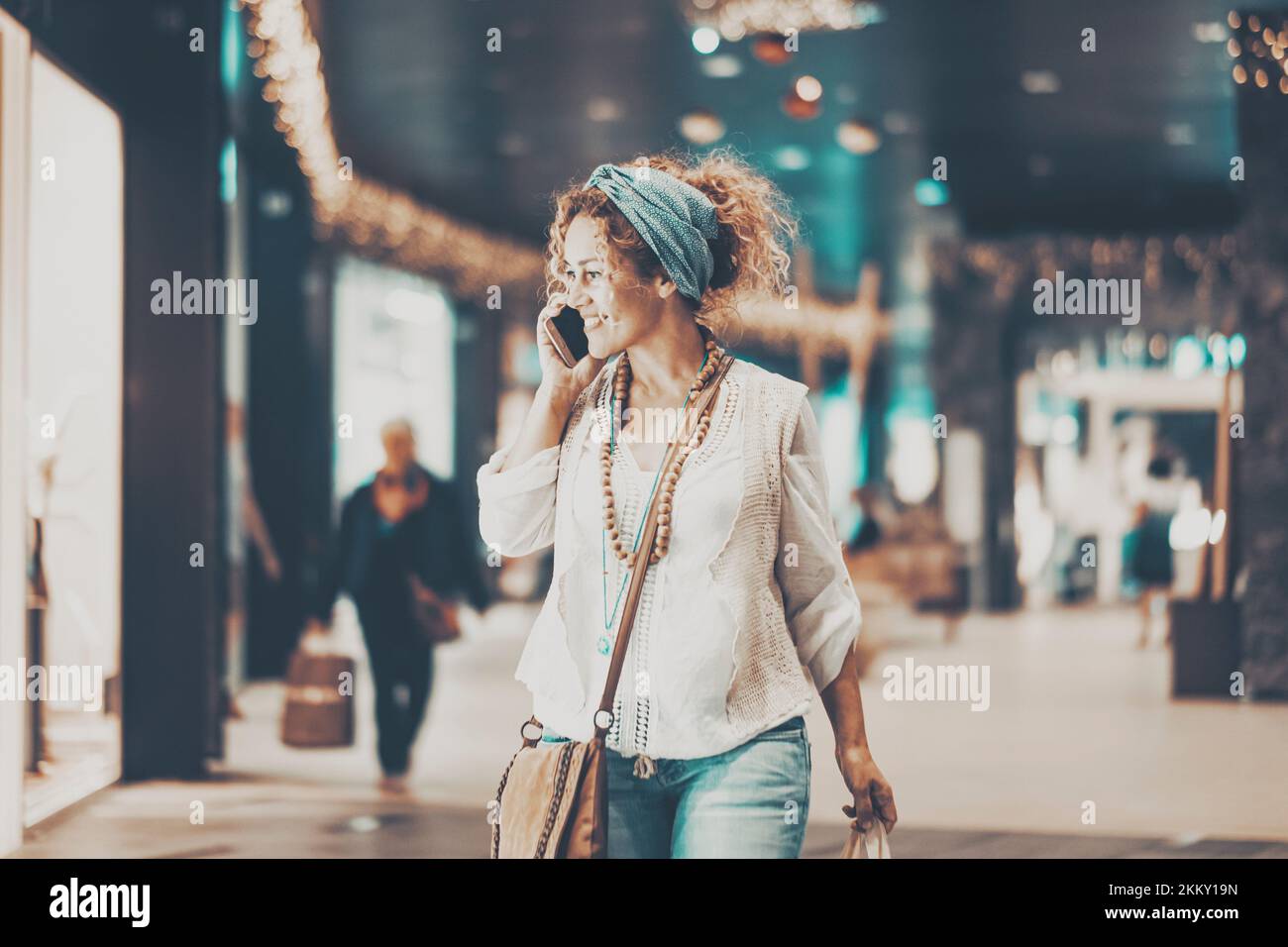 One woman smile and walk inside a commercial centre mall looking stores and garments. Shopping activity, Female people enjoy sales discount holiday se Stock Photo