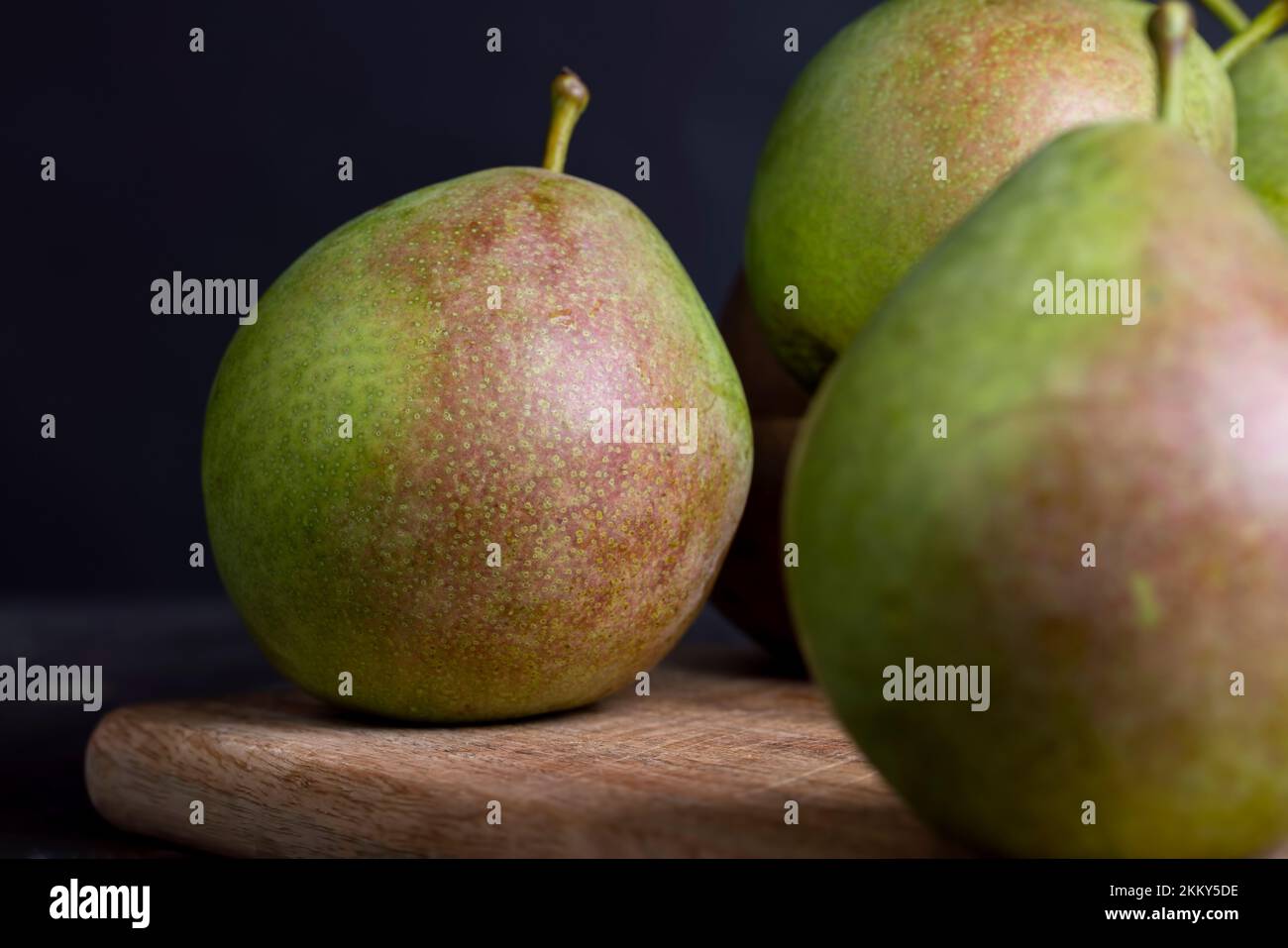 Whole ripe green pears, harvested green pears on the kitchen board ...