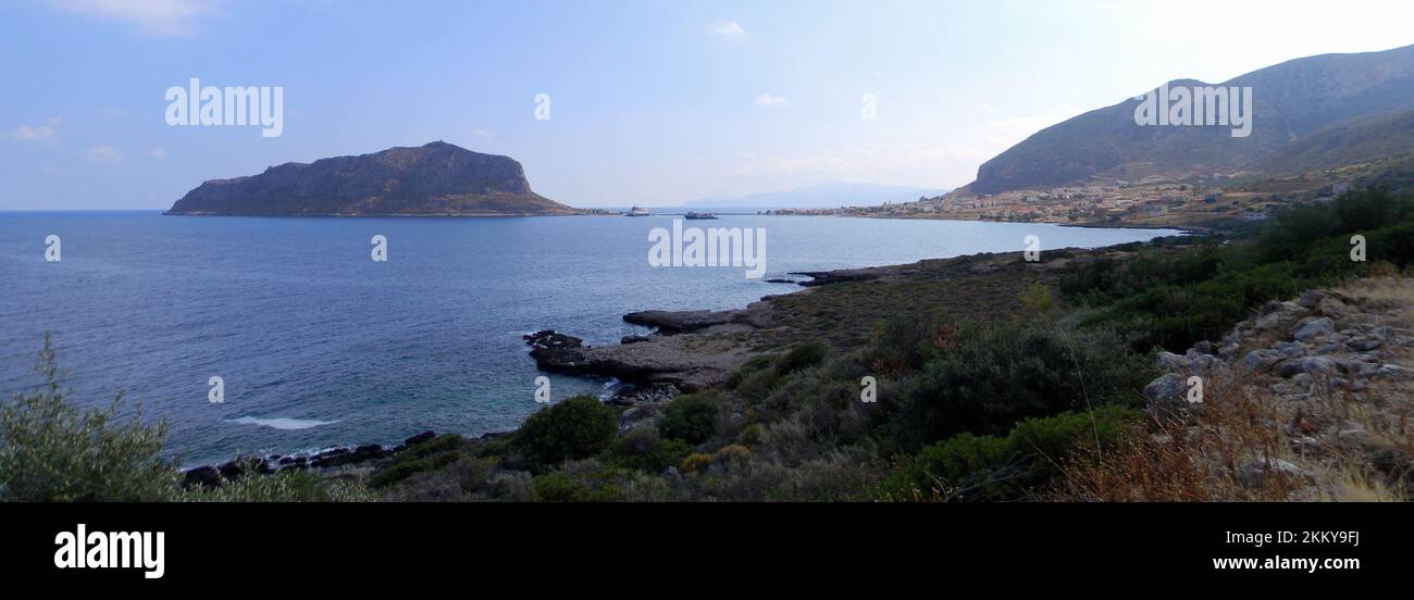 Panoramic view of the Aegean sea coast north of Monemvasia, island with a mountain, connected to the mainland by causeway, Peloponnese, Greece Stock Photo