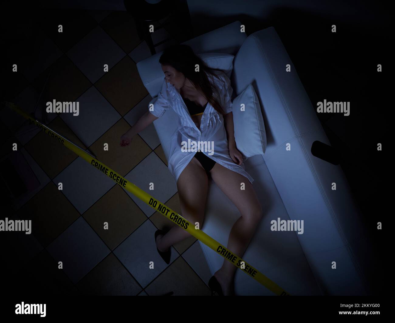 young woman lying dead on the floor after rape - crime scene Stock Photo