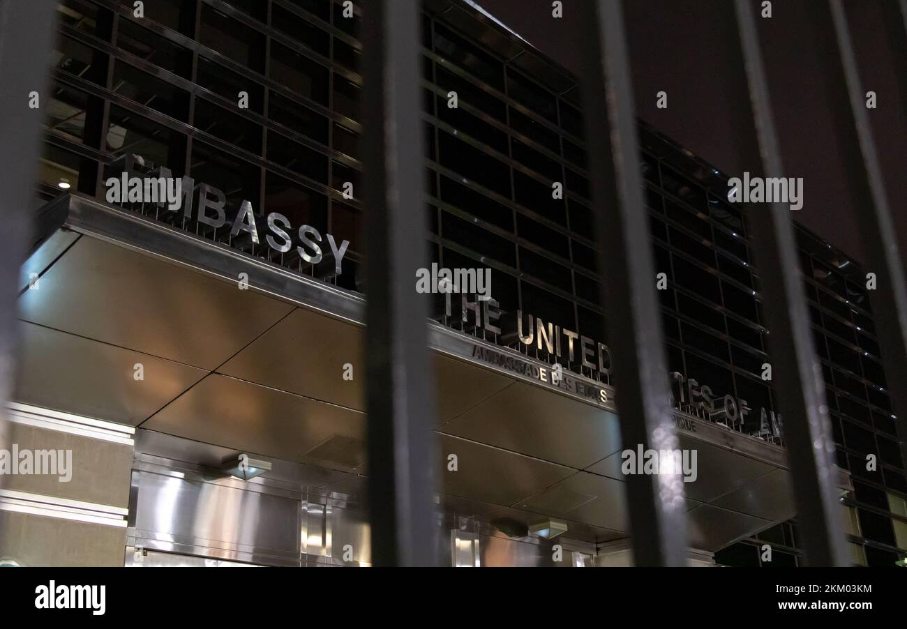 Behind the gate to the US Embassy in Ottawa, the sign above the main entrance is seen at night. Stock Photo