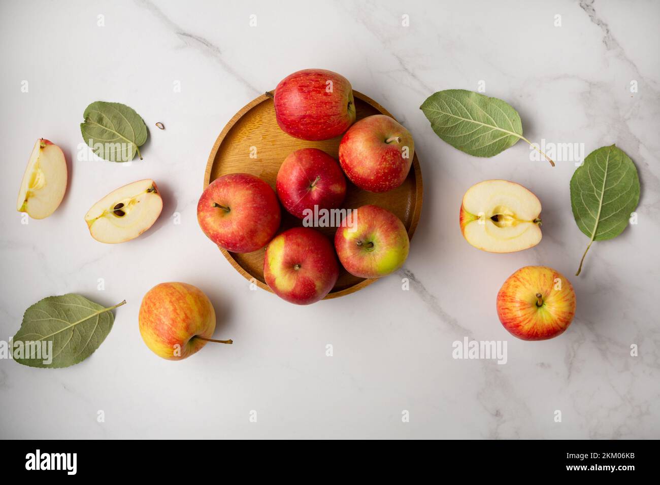 Fresh red and yellow apples on plate healthy food on light surface top view Stock Photo