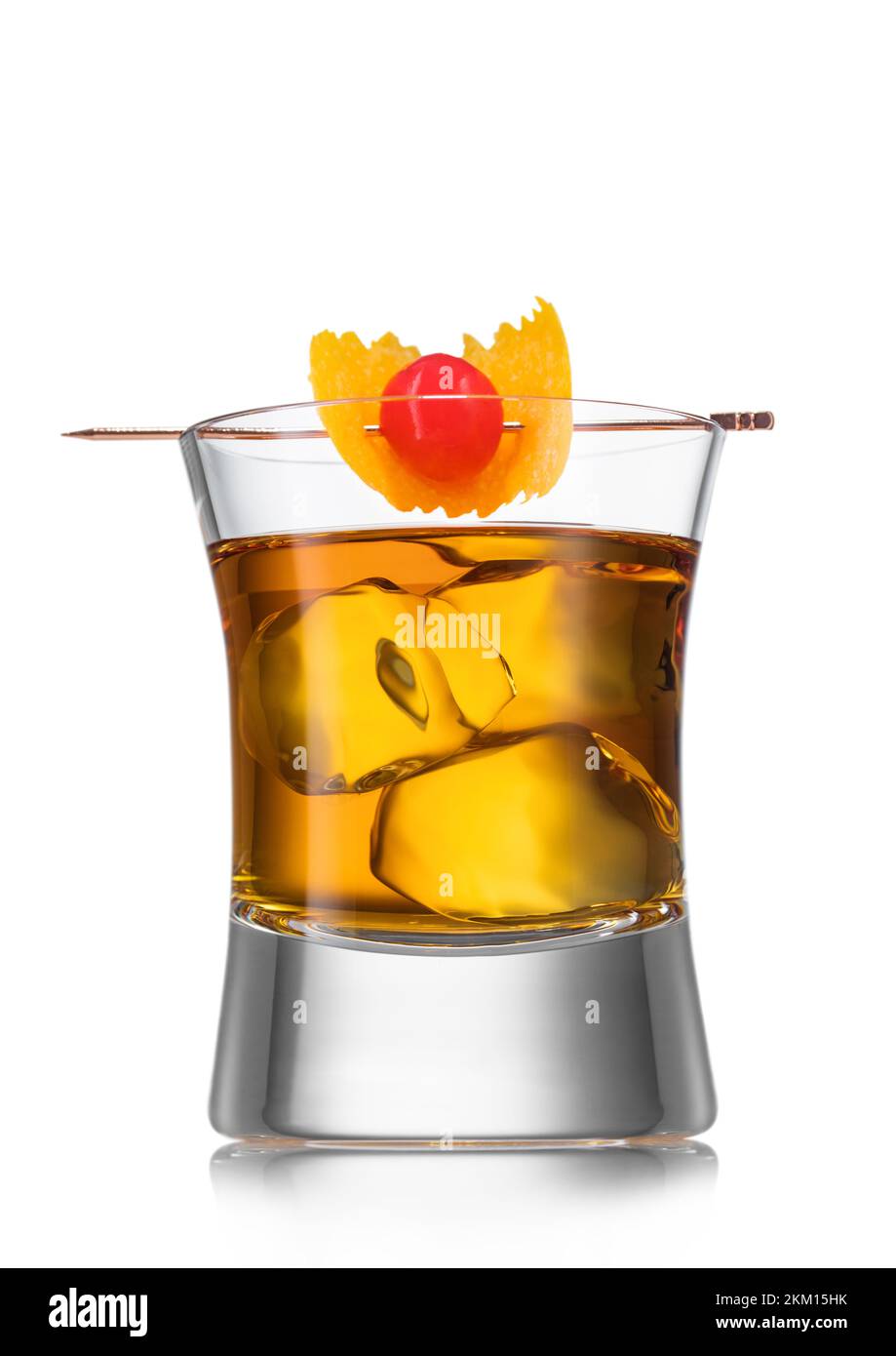 Glass with old fashioned cocktail and pick with cocktail cherry and