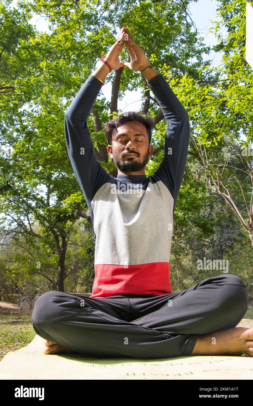 Young Man doing yoga with hands in prayer position at outdoor Stock ...