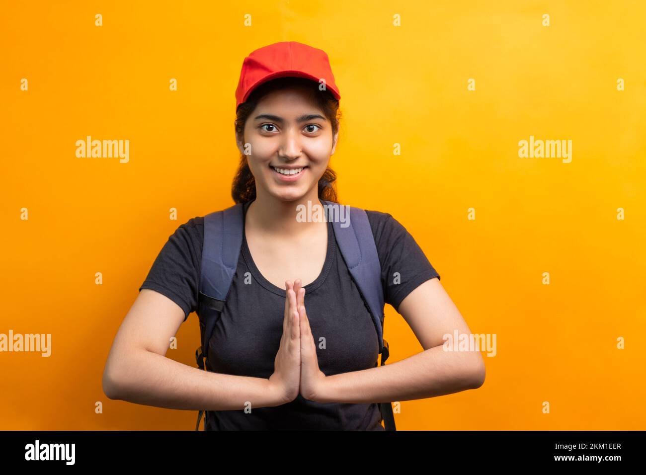 Young delivery Woman greeting with a smile Stock Photo