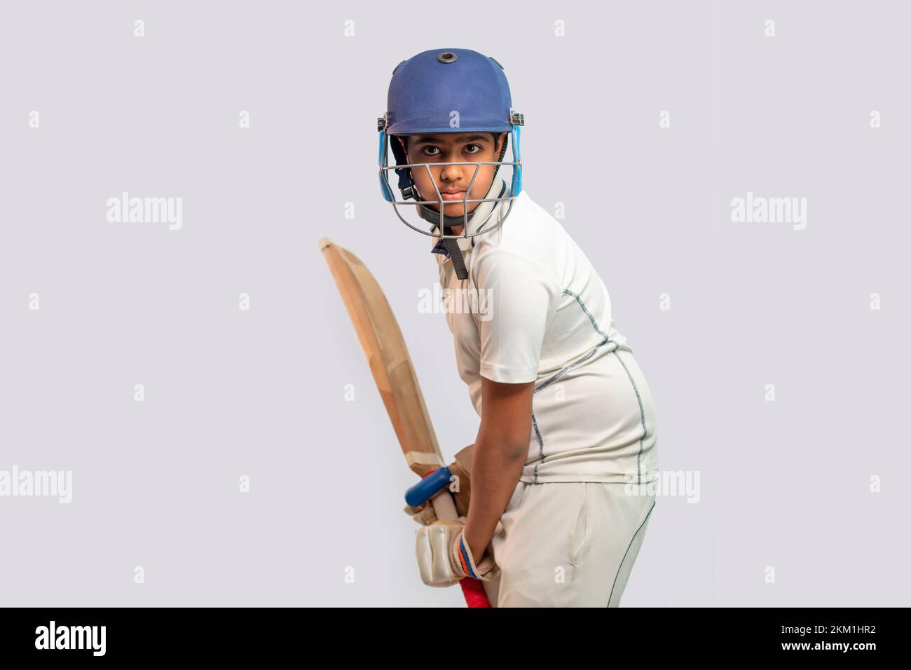Portrait of boy getting ready to strike During a Cricket Game Stock Photo