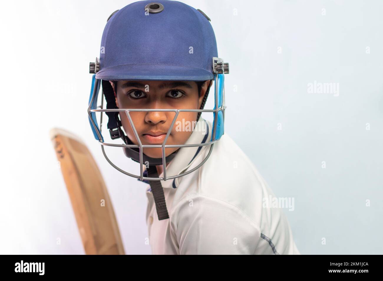 Portrait of boy getting ready to strike During a Cricket Game Stock Photo