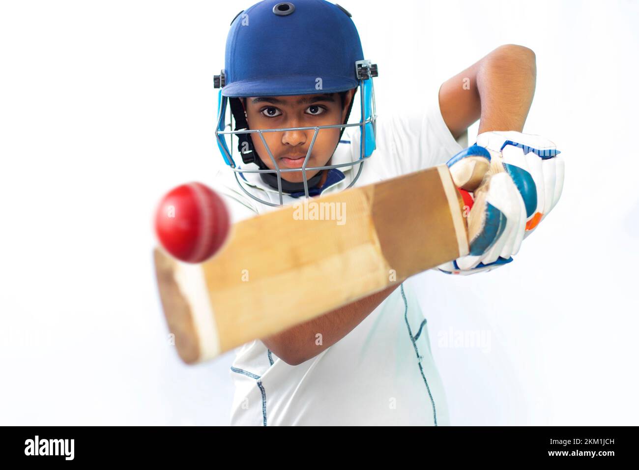 Portrait of boy hitting a shot  During a Cricket Game Stock Photo