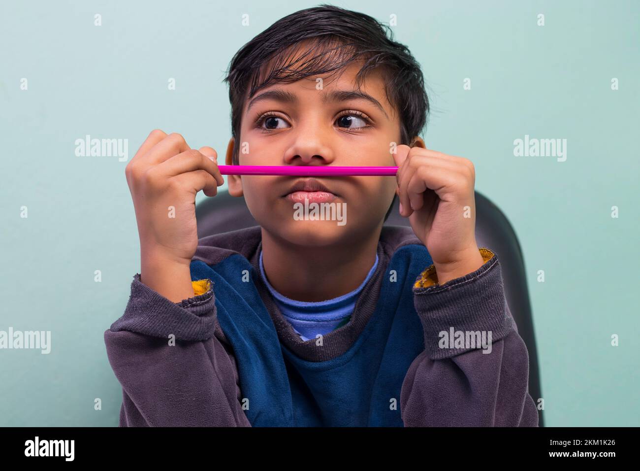 Boy with pencil under his nose Stock Photo Alamy