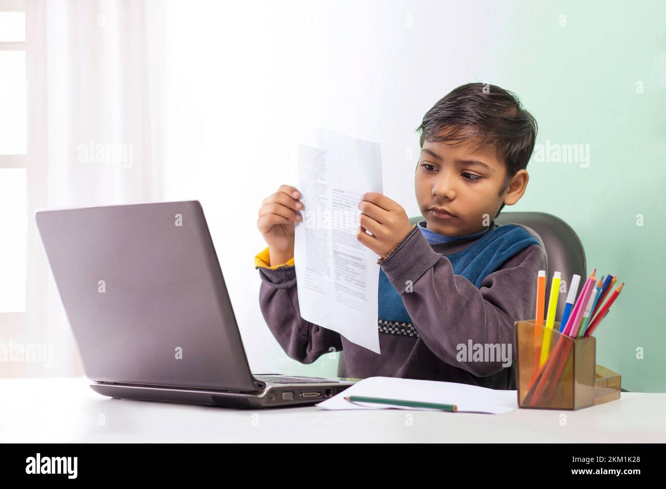 a boy showing report card online class Stock Photo