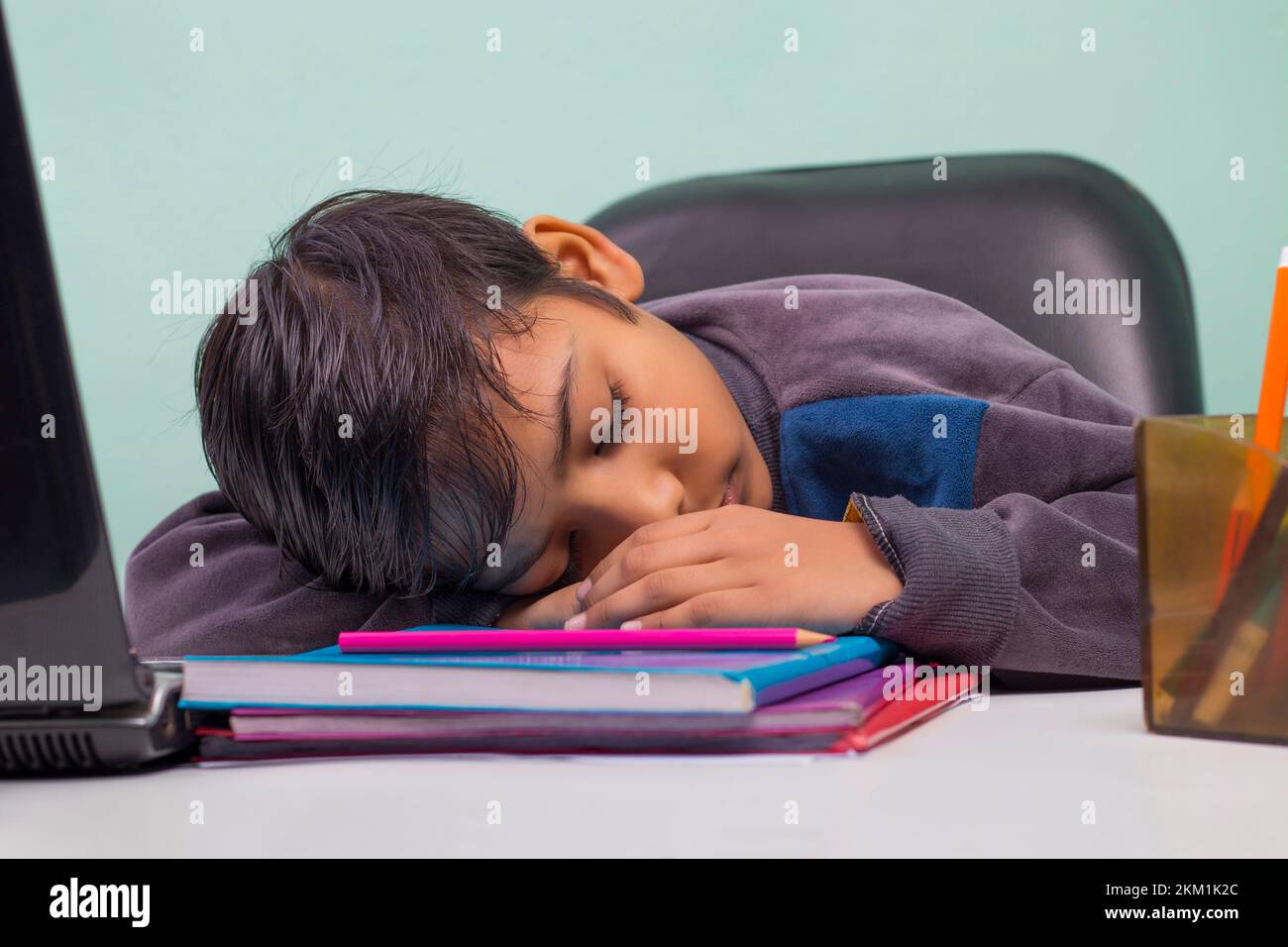 a boy laying down on table and Sleeping Stock Photo