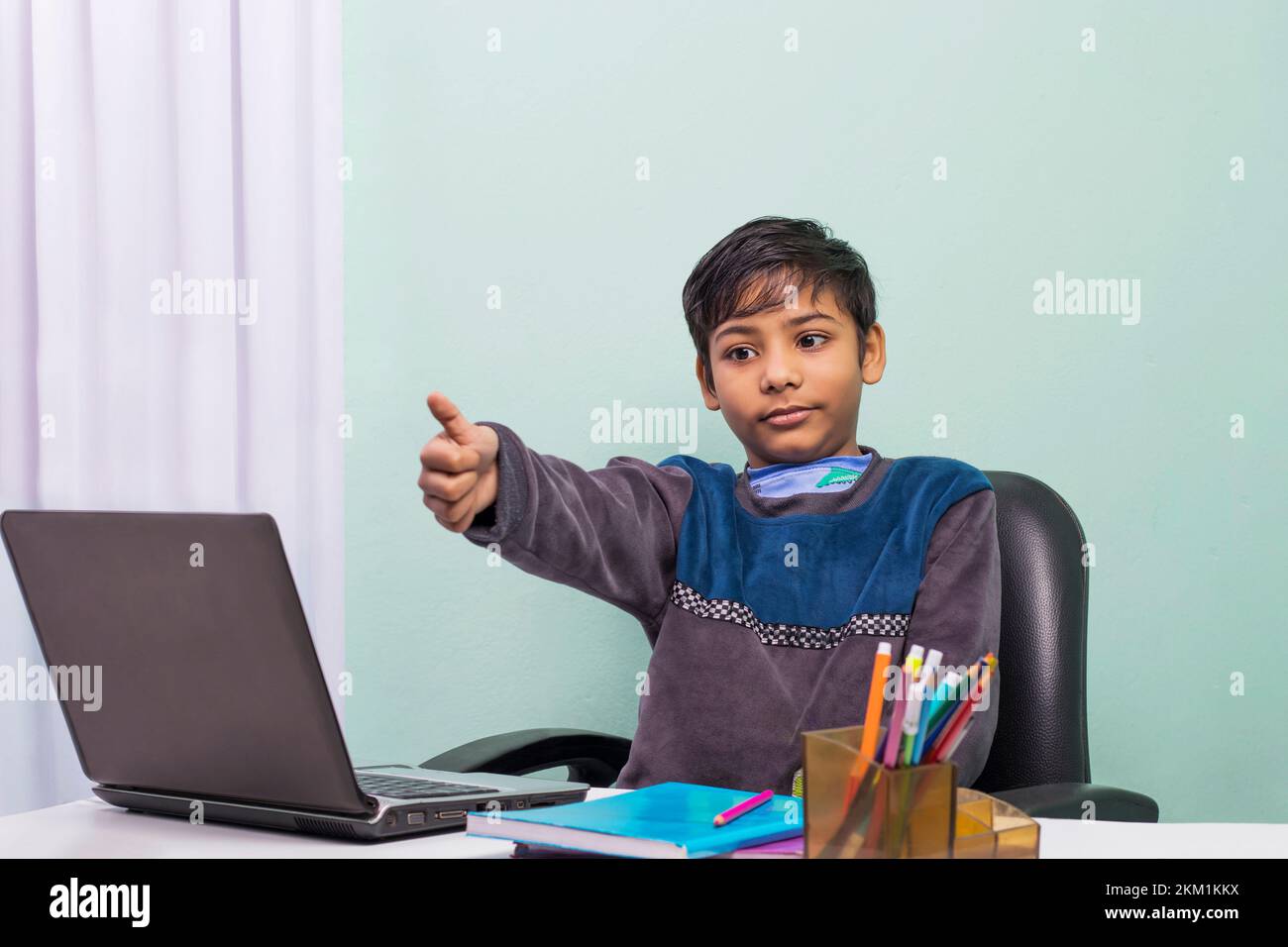 Little boys attending to online class from home. The school has been closed during coronavirus outbreak and the classes have moved to e-learning platf Stock Photo