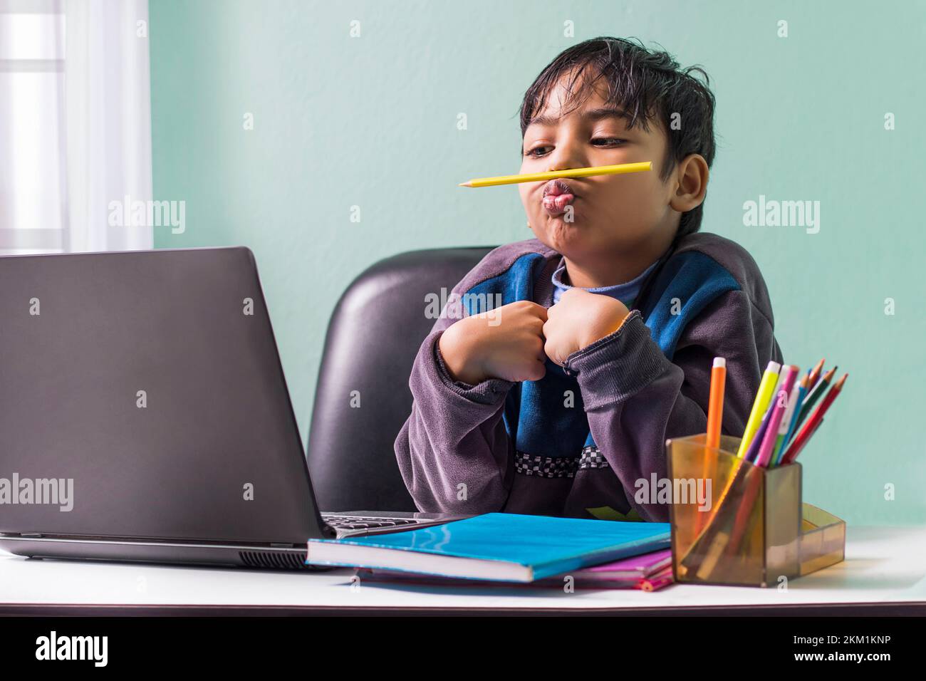 Boy with pencil under his nose Stock Photo