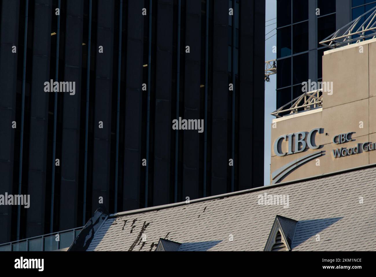 A chrome CIBC, Commerce Imperial Bank of Canada, logo is seen above a large CIBC bank branch and office in downtown Ottawa. Stock Photo