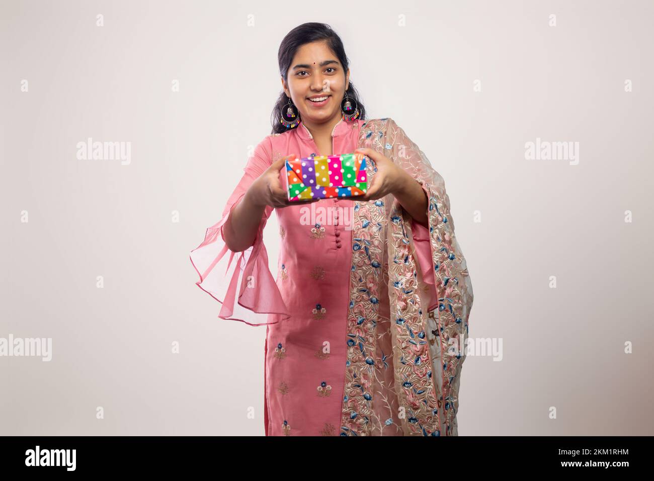 young Teenager girl  Giving a gift box on Diwali Stock Photo