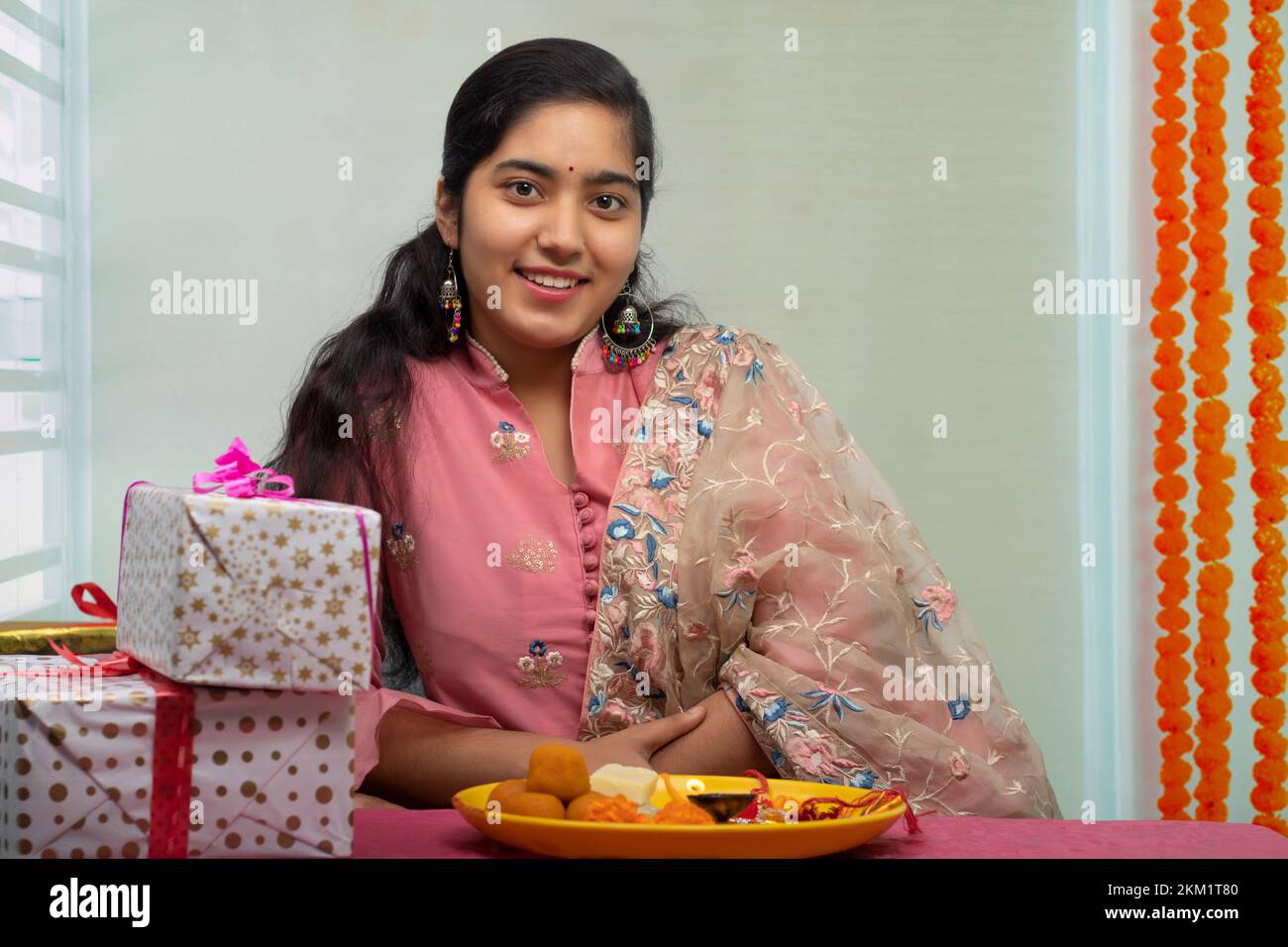 Portrait of a cheerful sister at home on the occasion of Raksha Bandhan Stock Photo