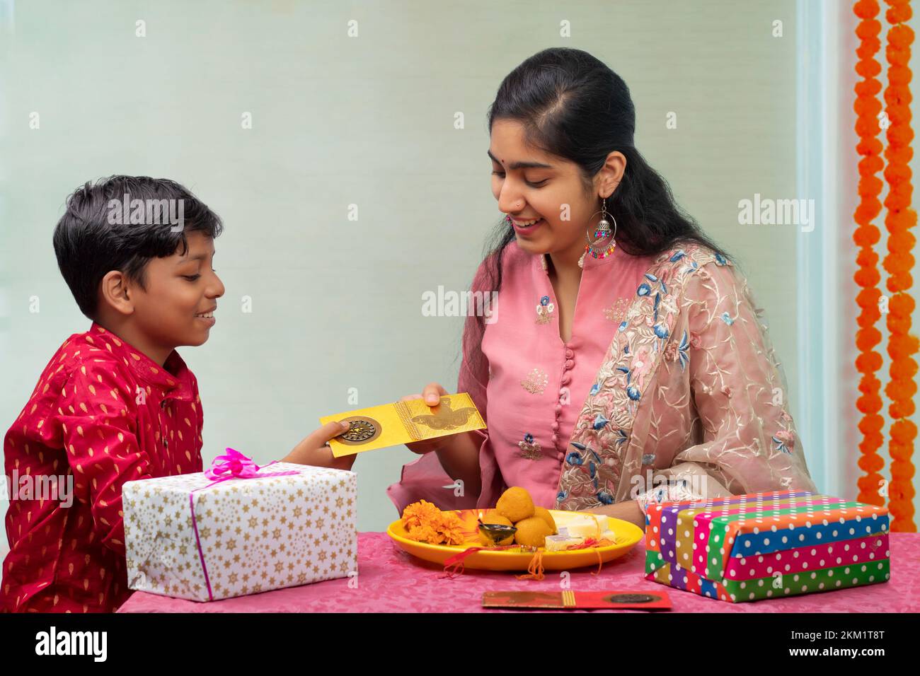 a young girl happily receiving gift on rakshabandhan Stock Photo