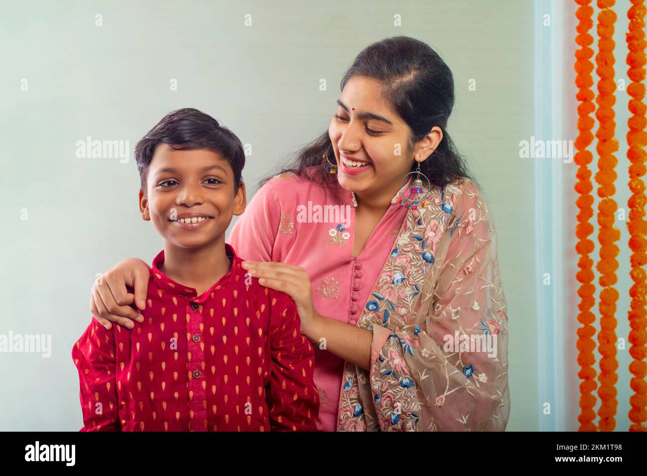 a happy brother and sister wearing a traditional dress and enjoying Stock Photo