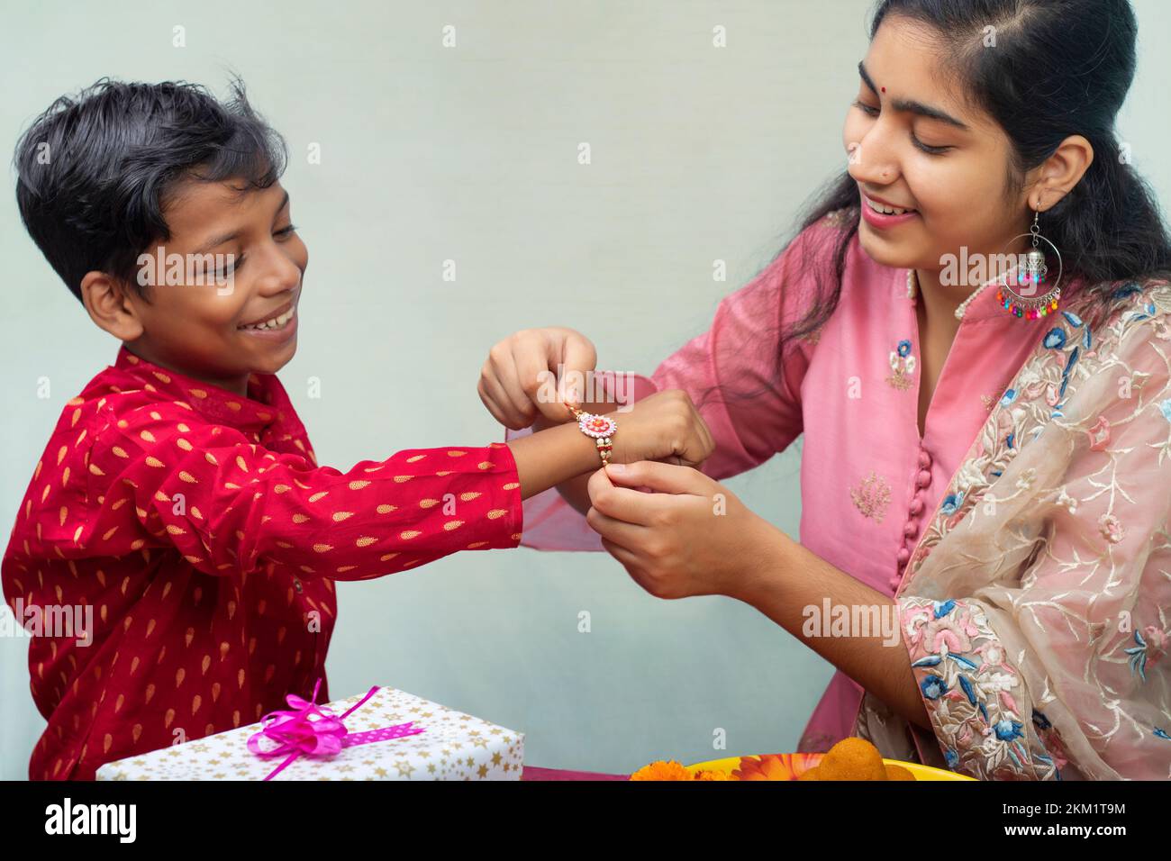 Sister tying rakhi on her brother's wrist on the occasion of Raksha Bandhan Stock Photo