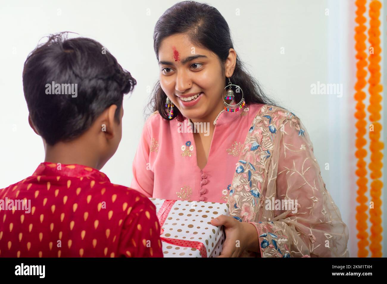 Brother giving gift to his sister on the occasion of Raksha Bandhan Stock Photo