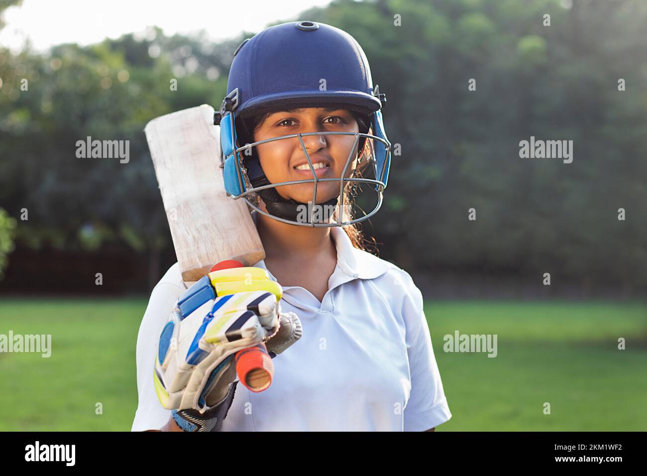 Portrait Of A Female Cricketer Holding A Cricket Bat Stock Photo