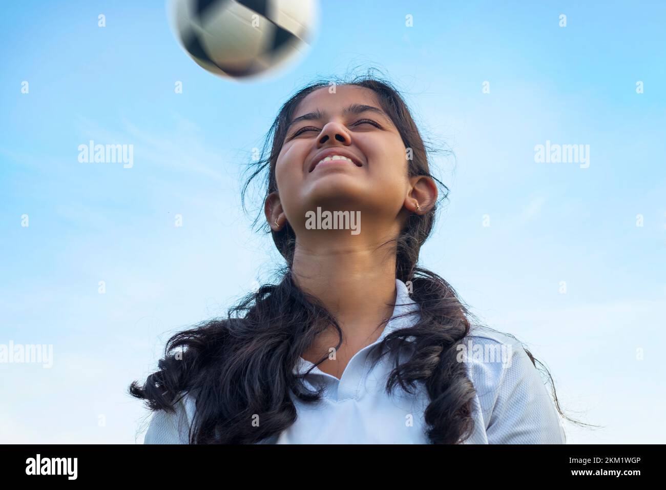 Female soccer striker heads ball into the goal Stock Photo Alamy