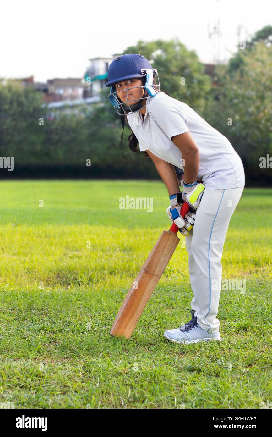 Female cricket players practice in the ground Stock Photo