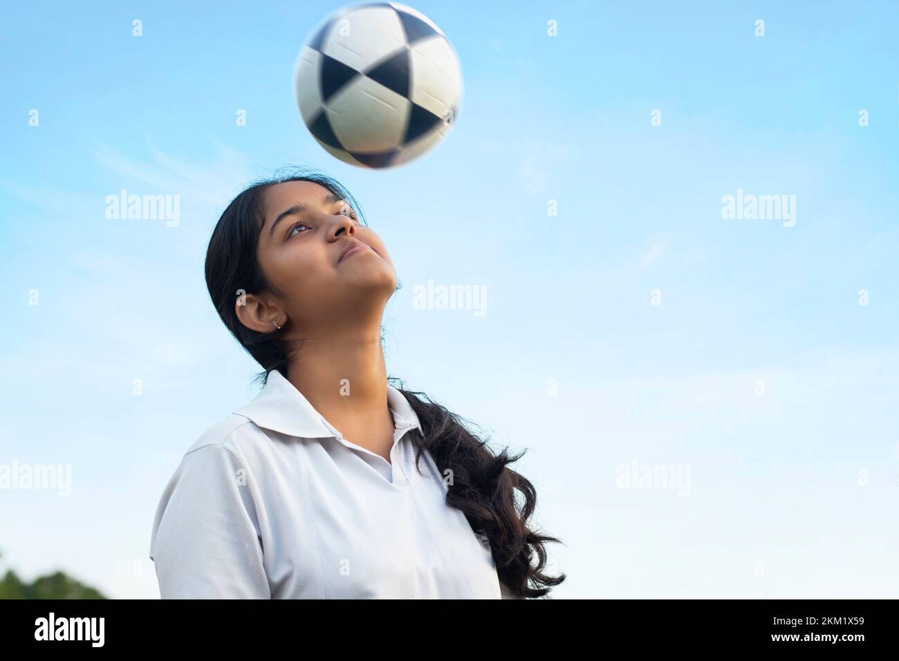 Female soccer striker heads ball into the goal Stock Photo Alamy