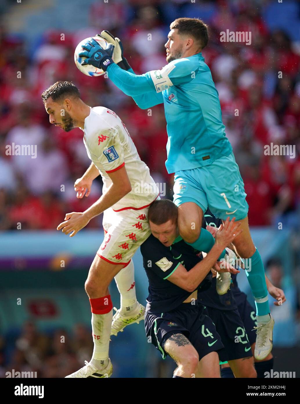 Australia goalkeeper Mathew Ryan (right) clashes into team-mate Kye Rowles whilst battling for the ball with Tunisia's Montassar Talbi during the FIFA World Cup Group D match at the Al Janoub Stadium in Al-Wakrah, Qatar. Picture date: Saturday November 26, 2022. Stock Photo