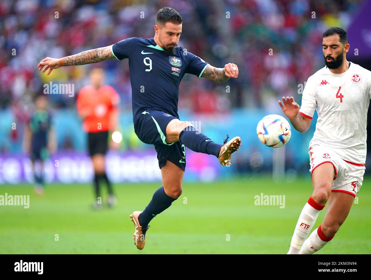 Australia's Jamie Maclaren (left) and Tunisia's Yassine Meriah battle for the ball during the FIFA World Cup Group D match at the Al Janoub Stadium in Al-Wakrah, Qatar. Picture date: Saturday November 26, 2022. Stock Photo
