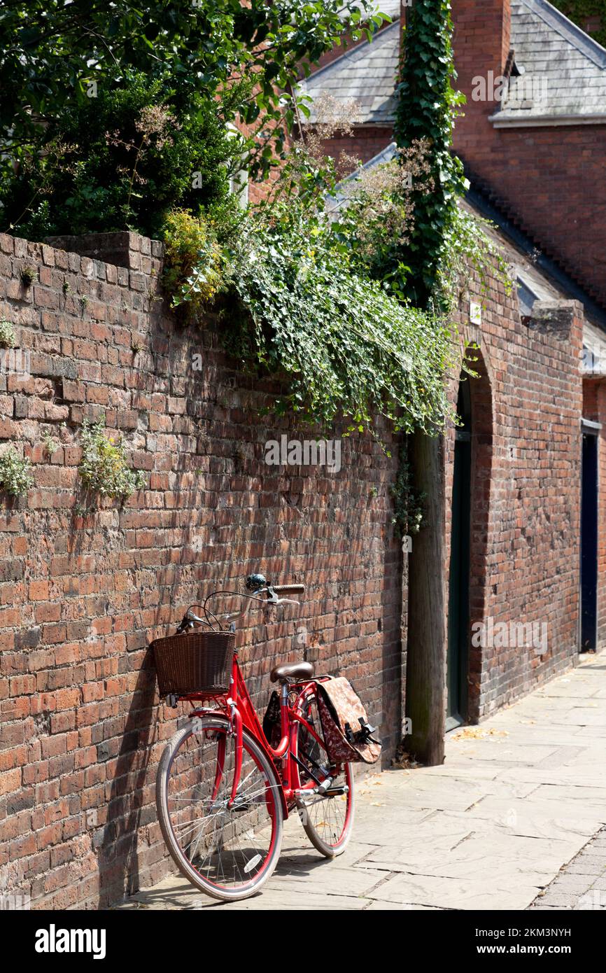 Bicycle leaning against wall in Church Street, Hereford, Herefordshire Stock Photo