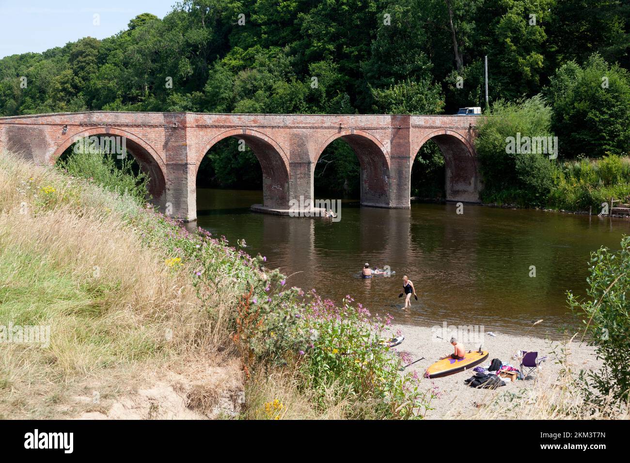 Bridge over the River Wye with people enjoying the hottest day on record, Bredwardine, Herefordshire Stock Photo