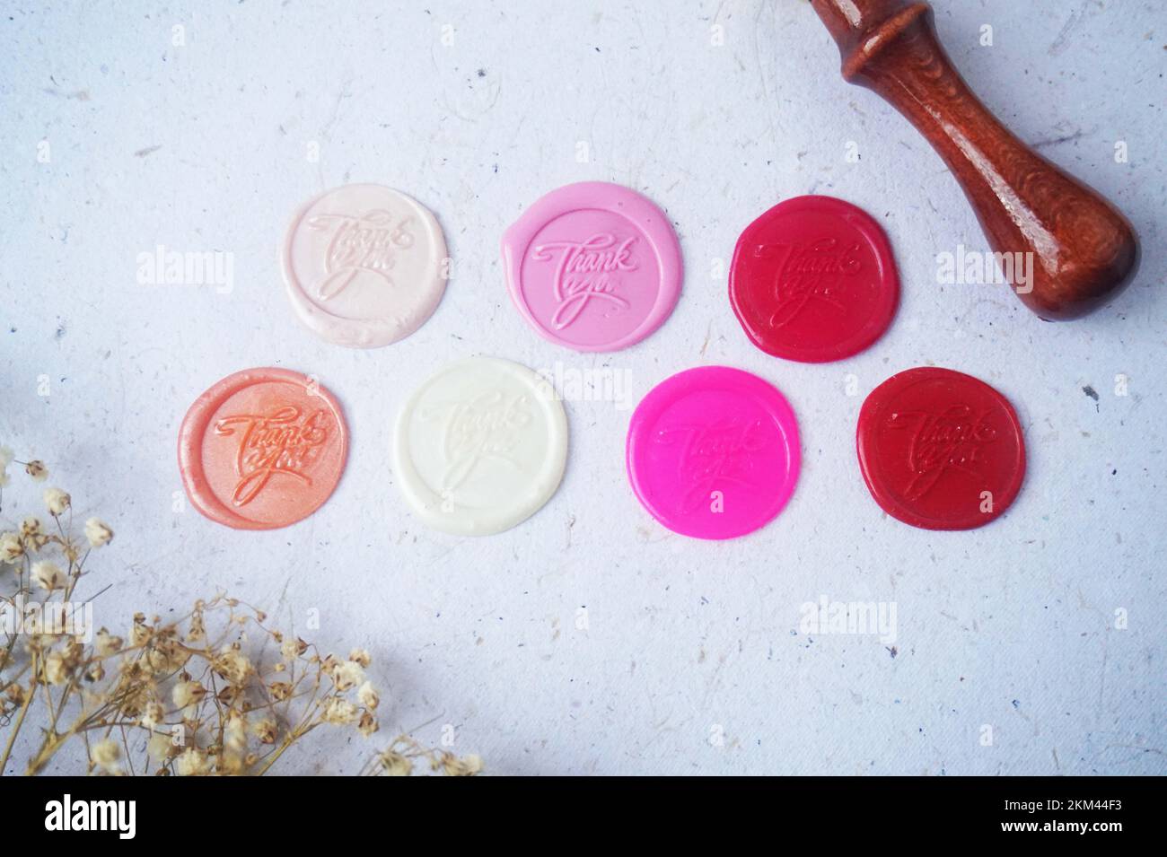 Pretty wax coins made from wax bead and stamp for a vintage look in letter or wedding invitation
