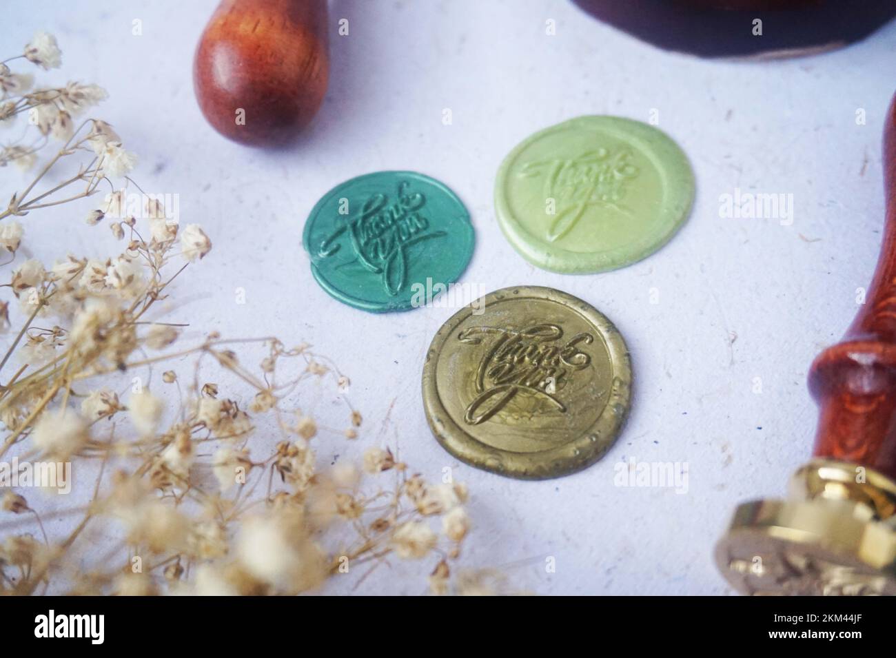Pretty wax coins made from wax bead and stamp for a vintage look in letter or wedding invitation