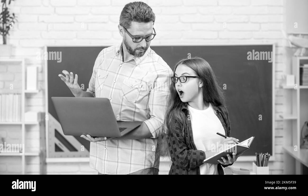 amazed-teen-girl-and-teacher-man-in-high-school-with-workbook-at