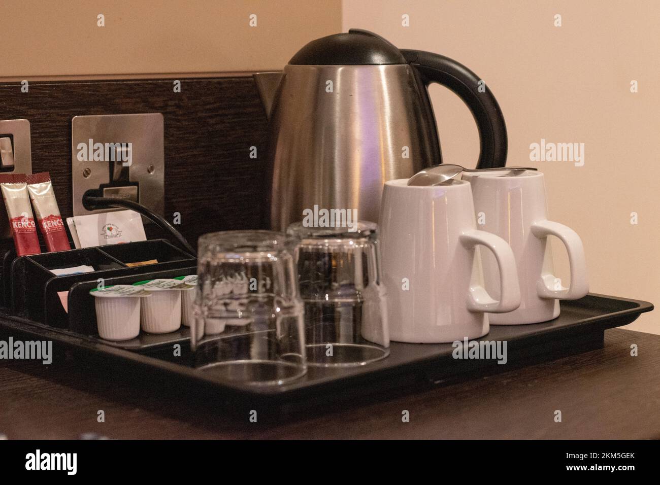 Coffee and tea making facilities cups glasses and kettle in hotel room - UK hotel chain Premier Inn Stock Photo