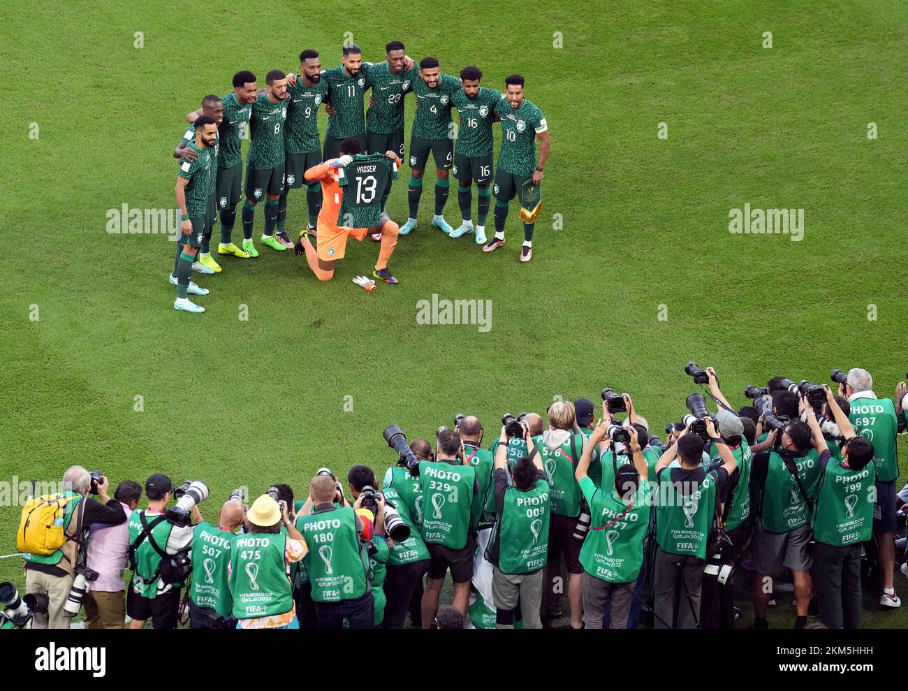 Saudi Arabia players line up and hold up a shirt with the name of their injured team-mate Yasser Al-Shahrani before the FIFA World Cup Group C match at the Education City Stadium in Doha, Qatar. Picture date: Saturday November 26, 2022. Stock Photo
