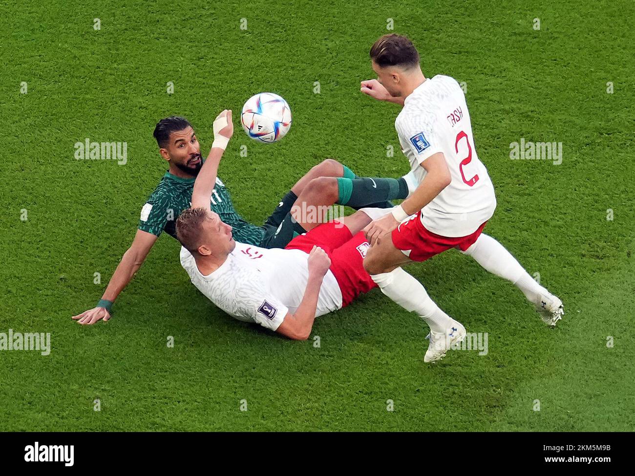 Saudi Arabia's Saleh Al-Shehri battles for the ball with Poland’s Matty