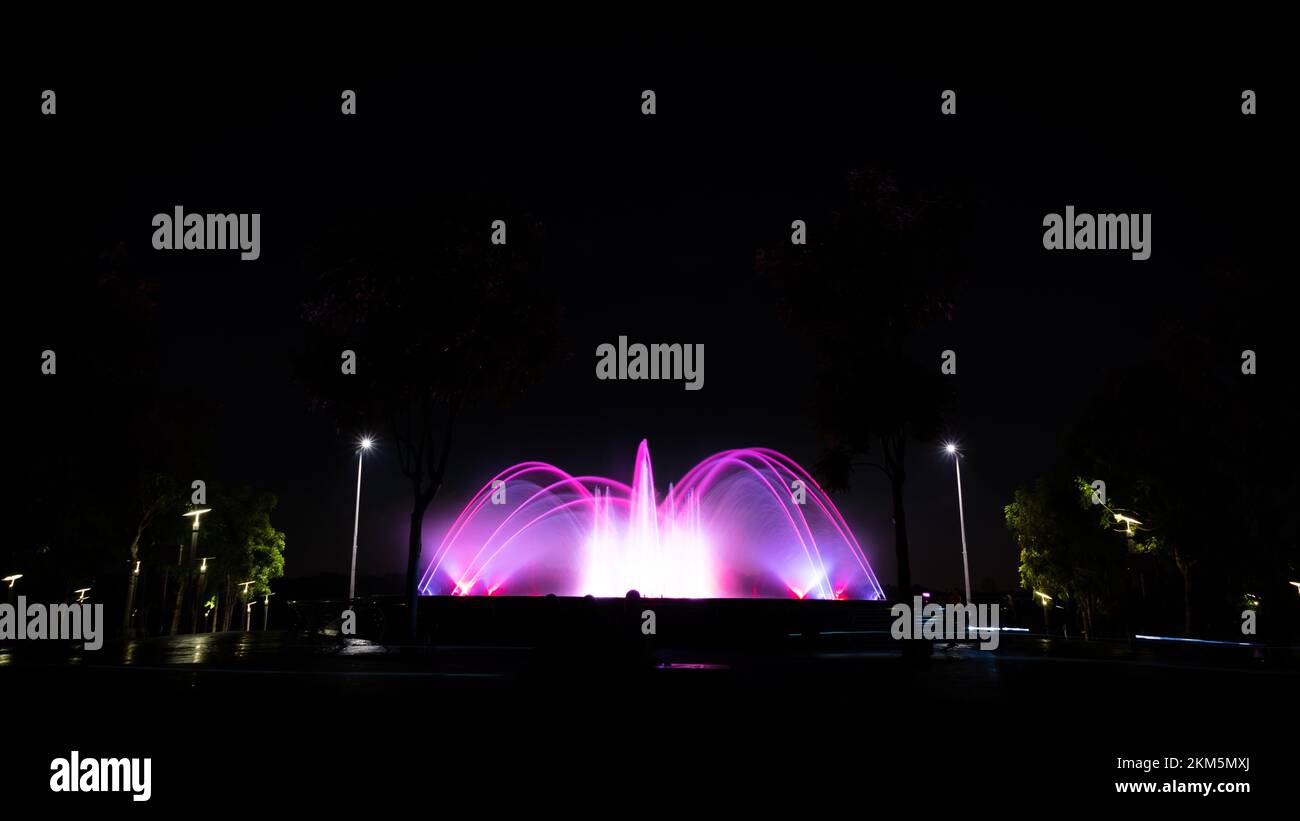 A night view of the glowing fountains in Puteri Harbour Iskandar ...