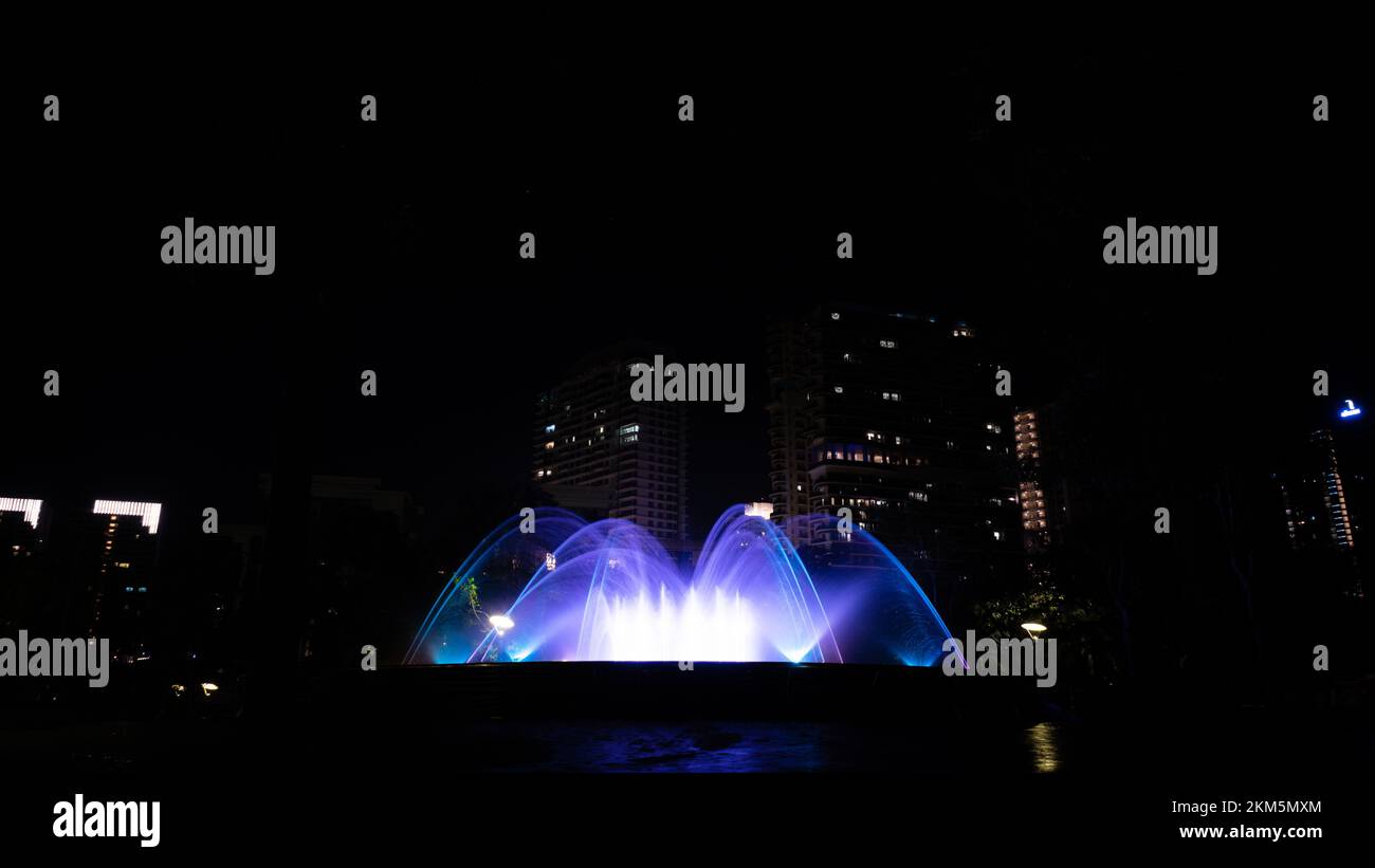 A night view of the glowing fountains in Puteri Harbour Iskandar ...