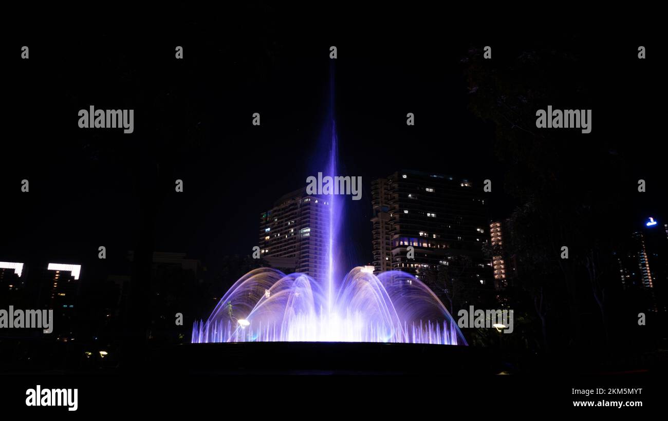A night view of the glowing fountains in Puteri Harbour Iskandar, Malaysia Stock Photo