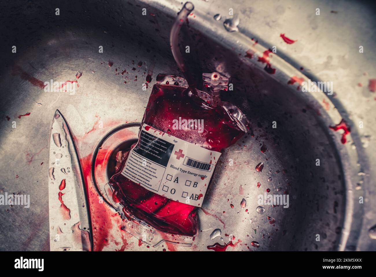 Scary horror still life photo on a blood bag with knife in metallic sink.  Only in a vampires kitchen Stock Photo - Alamy