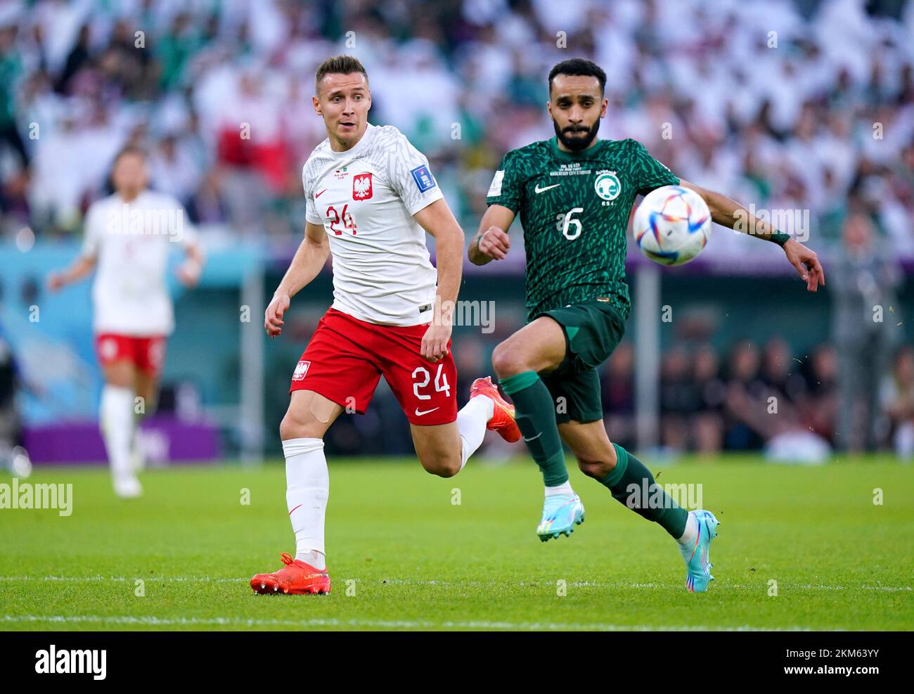 Poland's Przemyslaw Frankowski (left) and Saudi Arabia's Mohammed Al-Breik battle for the ball during the FIFA World Cup Group C match at the Education City Stadium in Doha, Qatar. Picture date: Saturday November 26, 2022. Stock Photo