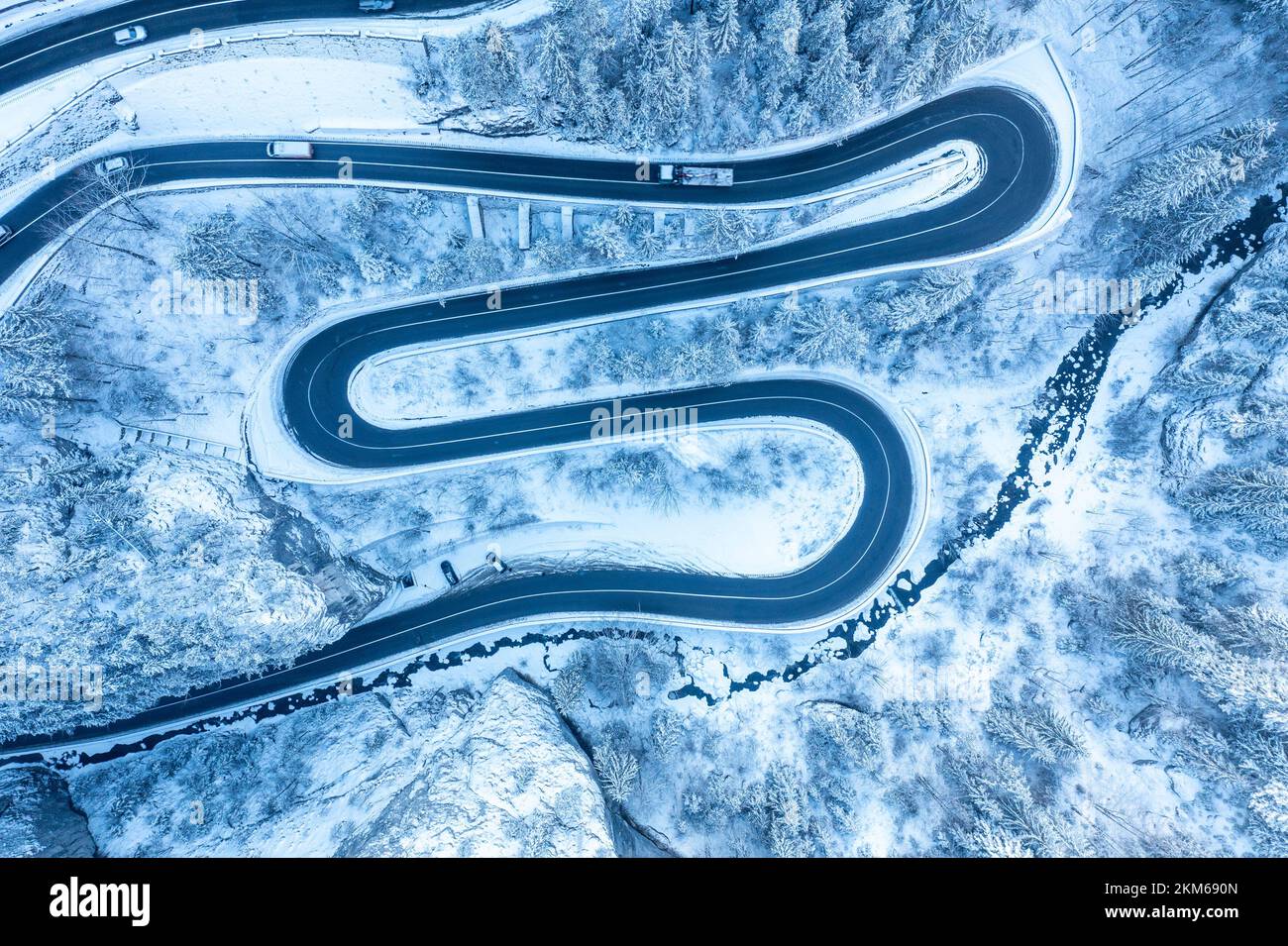 Carpathian, Romania, 2021-12-28. Aerial view of a mountain road under snow. Stock Photo