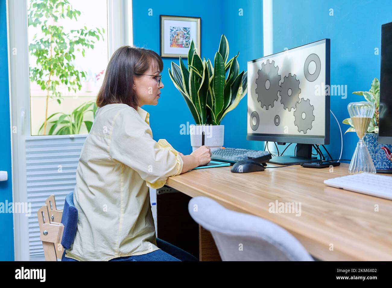 Middle aged female graphic designer working from home Stock Photo